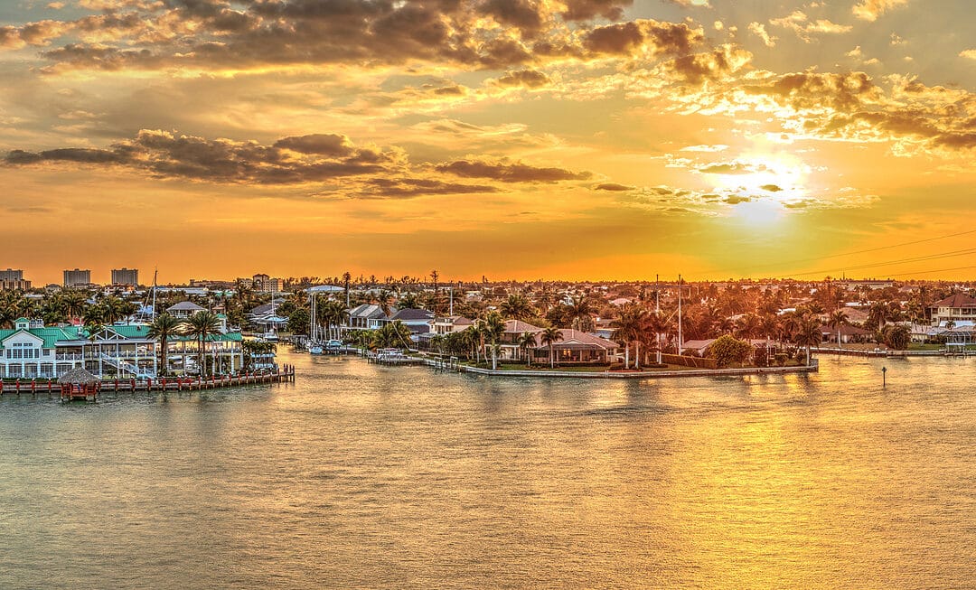 Golden Sky Over City Lights Across Factory Bay In Marco Island,